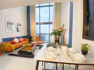 a living room with a table with dishes on it at ICON CITY PETALING JAYA By WeCare in Petaling Jaya