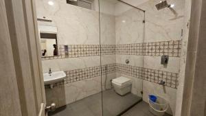 a bathroom with a toilet and a sink and a shower at Celestial Nymph by Natureloom in Vagamon +31 photos