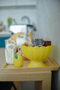 a yellow bowl sitting on top of a wooden shelf at RIVER VIEW & Private Parking - Baia Mare in Baia Mare