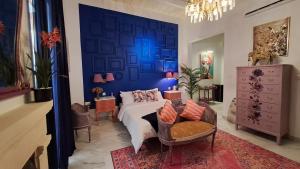 a bedroom with a bed and a blue wall at Melita Living in Sliema