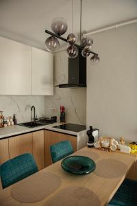 a kitchen with a table with a green plate on it at RIVER VIEW & Private Parking - Baia Mare in Baia Mare