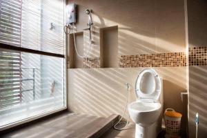 a bathroom with a white toilet and a shower at Home Sukhumvit 49 Soi 14 in Bangkok +12 photos
