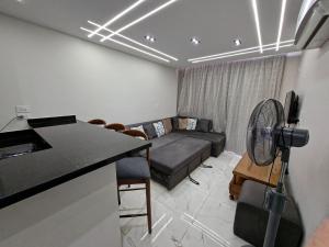 a living room with a couch and a table with a fan at شاليه غرفتين ببورتوسعيد للعائلات فقط in Port Said