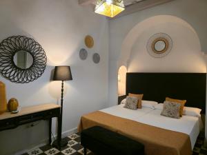 Llit o llits en una habitació de La Gitanilla Alojamiento & Encanto Jerez