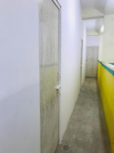 an empty hallway with a door in a room at HR home stay in Chennai