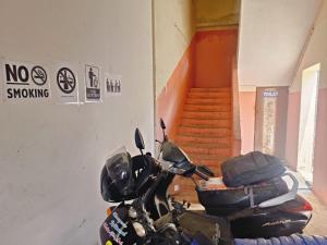 a motorcycle parked in a room with a staircase at HR home stay in Chennai