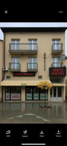 a large building with a sign for a hotel at METRO Hotel in Gusinje