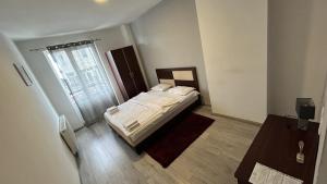 a small bedroom with a bed and a window at METRO Hotel in Gusinje