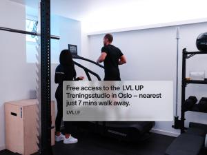 a man and a woman standing next to a whiteboard in a gym at Numa Oslo Topp in Oslo