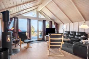 a living room with a couch and a fireplace at FY187-Asperup-Bogevangsvej-1 in Asperup