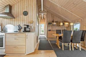a kitchen and dining room with a table and chairs at FY187-Asperup-Bogevangsvej-1 in Asperup +10 photos