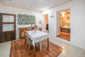 a dining room with a white table and chairs at San José Moratalla in Moratalla