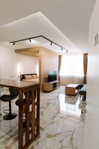 a living room with a table and a couch at Gallus Inn in Aleksinac