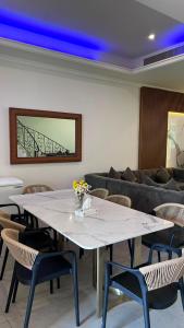 a large white table with chairs and a couch at فيلا درة العروس 2 in Durat Alarous +44 photos