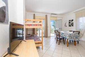 a living room with a bunk bed and a table at I Ciottoli Dello Ionio in Mascali