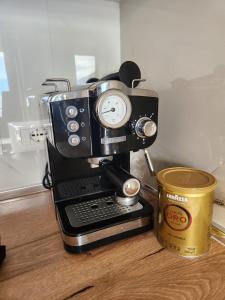 a coffee maker and a cup on a table at Lakefront House in Pogradec +6 photos