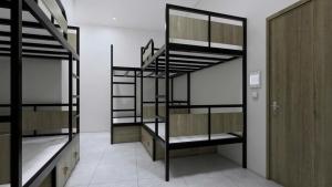a room with four bunk beds and a door at Green Hostel Hanoi 2 in Hanoi