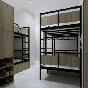 a room with three bunk beds in a room at Green Hostel Hanoi 2 in Hanoi