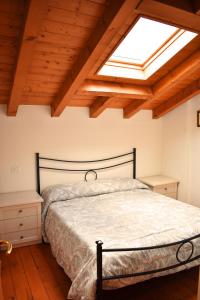 a bedroom with a bed and a skylight at Residence La Pineta in Serina +218 photos
