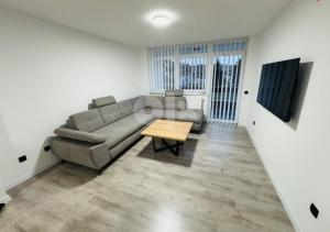 a living room with a couch and a table at Stan na dan Tuzla in Tuzla