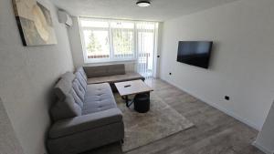 a living room with a couch and a table at Stan na dan Tuzla in Tuzla +6 photos
