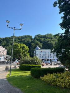 a park with a street light and a building at Week end à Spa in Spa