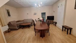 a living room with a table and a couch at Cottages Delloress in Jūrmala