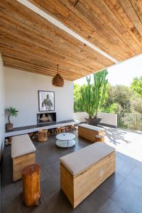 a living room with wooden ceilings and tables and benches at Afrika House in Nairobi
