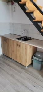 a kitchen with a sink and a counter top at Hotel in Surami