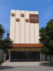 a building with eyes painted on the side of it at Arthana Grand Inn in Udumalaippettai