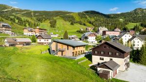 an aerial view of a small village in the mountains at Hideaway Planneralm operated by JUFA Hotels in Planneralm