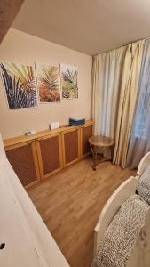 a room with a bed and a table in a room at Cottages Delloress in Jūrmala