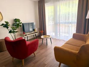 a living room with a couch and a tv at DOMITYS - L'Alezane in Saint Lo