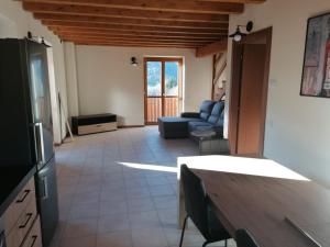 a living room with a couch and a table at Residence La Pineta in Serina