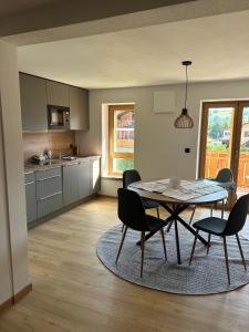 a kitchen and dining room with a table and chairs at Landhaus Sonnenwang in Pfronten