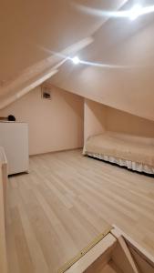 an empty room with a bed in the ceiling at Cottages Delloress in Jūrmala