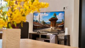 a flat screen tv sitting on a stand in a living room at Rakovica Resort in Sarajevo
