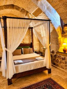 a bedroom with a bed with curtains in a room at Zuwinasa House Hotel in Avanos +64 photos