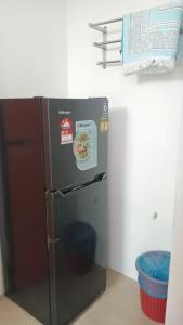 a small refrigerator in a small kitchen with a basket at 7Rooms Hotel Budget in Bandar  Pusat Jengka