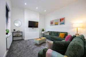 a living room with a couch and a tv at The Loft Apartment in Elland