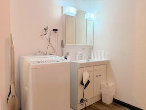 a small bathroom with a washer and a sink at ura 花れ -hanare- in Okayama +31 photos