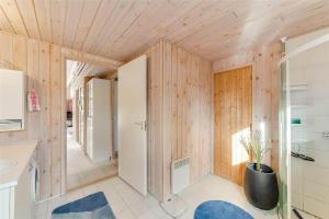 a bathroom with wooden walls and a sink and a toilet at 30035-Malling-Pilelokken-16 in Malling
