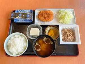 a tray of food with rice beans and other foods at Hotel Yamadaso in Nago
