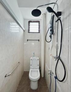 a bathroom with a shower with a toilet and a phone at 7Rooms Hotel Budget in Bandar  Pusat Jengka