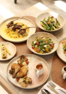 a group of plates of food on a table at JW Marriott Ranthambore Resort & Spa in Sawāi Mādhopur