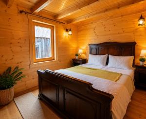 a bedroom with a large bed in a log cabin at Sea View Luxury Chalet in Šušanj +4 photos
