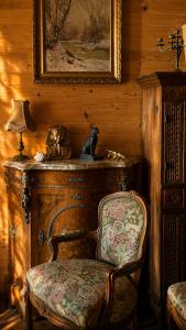 a chair in a room with a painting and a picture at Sea View Luxury Chalet in Šušanj