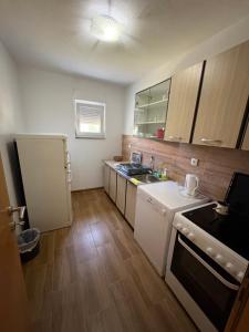 a small kitchen with a sink and a refrigerator at Sobe DANA Banja Vrućica in Teslić +5 photos