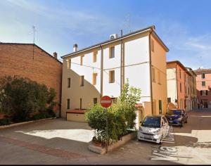 a car parked in a parking lot next to a building at Riolo Terme Camere in Riolo Terme