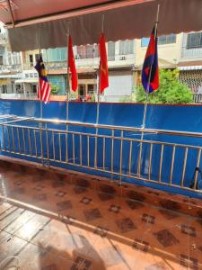 a blue boat with flags on the deck at TANJIL RESTAURANT & Guesthouse in Phnom Penh
